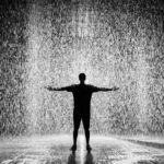 Silhouette and Grayscale Photography of Man Standing Under the Rain