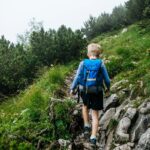 a boy walking on a rock