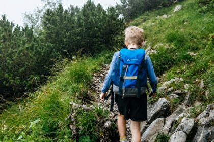 a boy walking on a rock