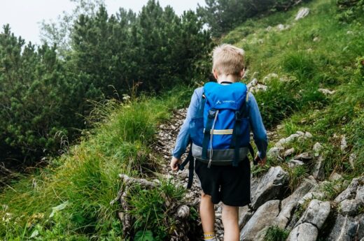 a boy walking on a rock