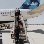 people walking on plane stair during daytime