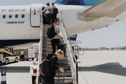 people walking on plane stair during daytime