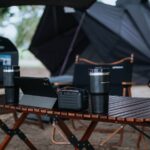 a table with a laptop and speakers