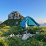 A tent pitched up on top of a mountain