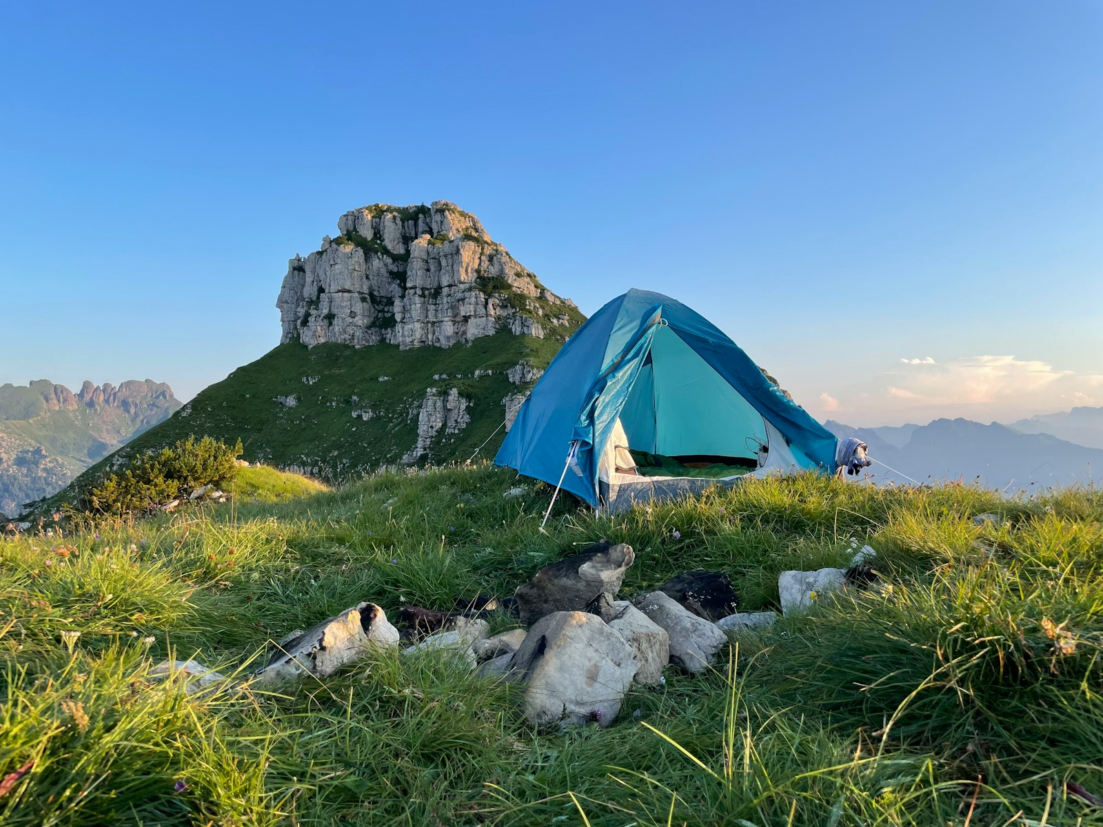 A tent pitched up on top of a mountain